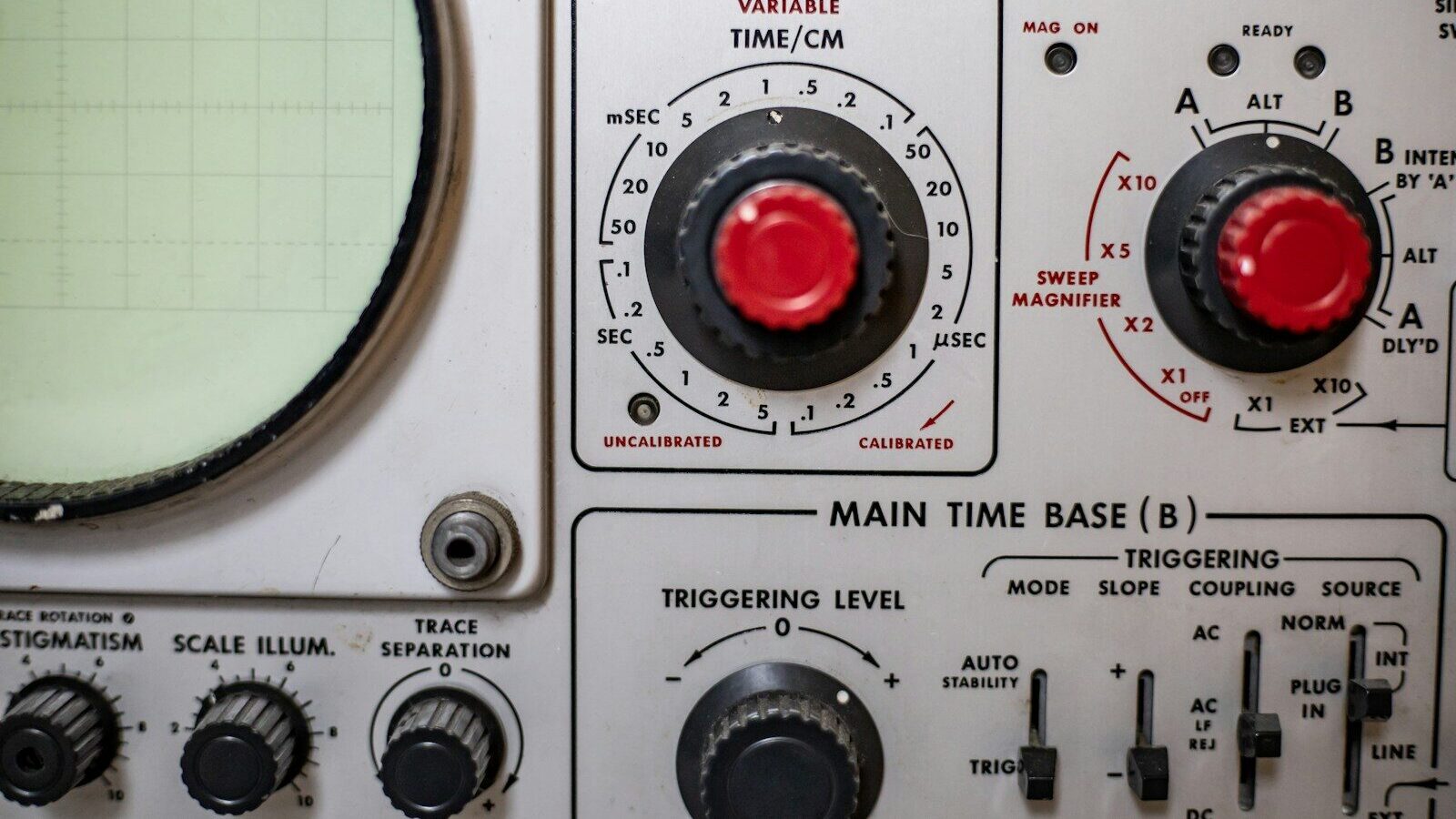 a close up of a machine with red knobs